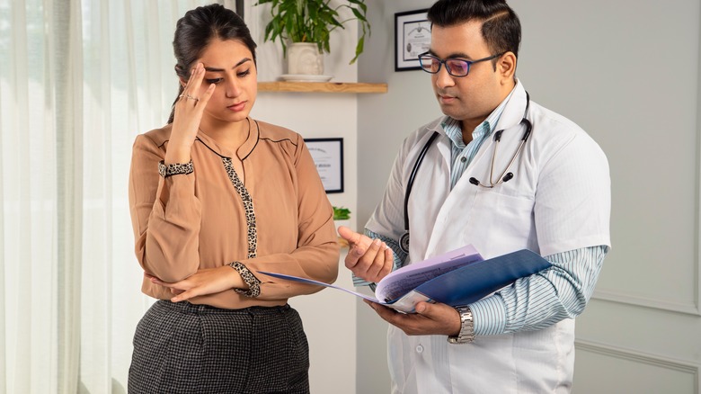 Woman looking at the results her doctor is showing her