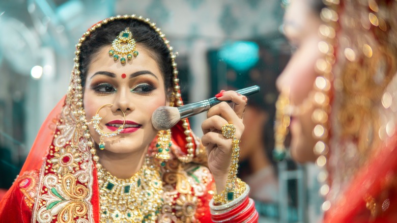 Indian bride touching up her makeup