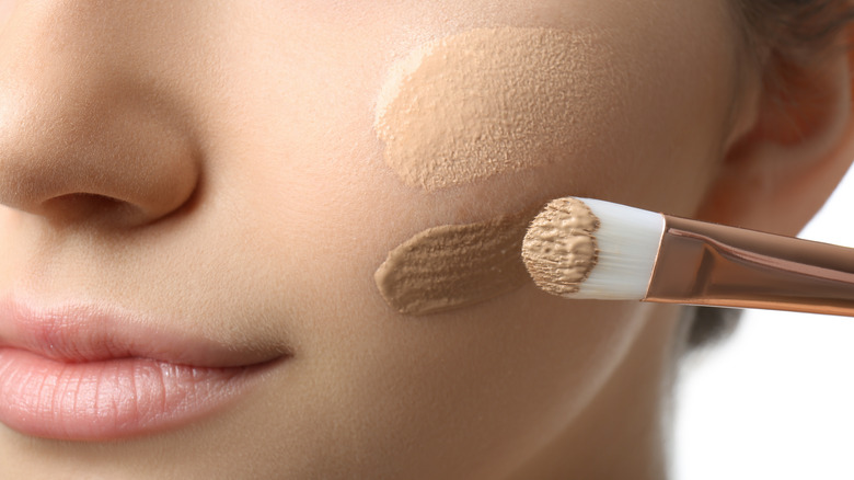 Woman applying foundation 