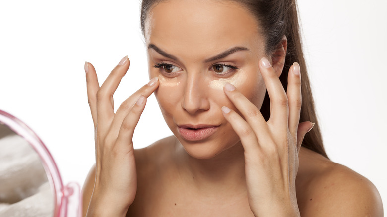 Woman putting on makeup primer 