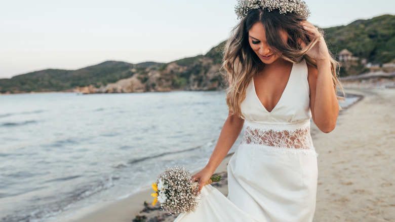 Bride walking on the beach 