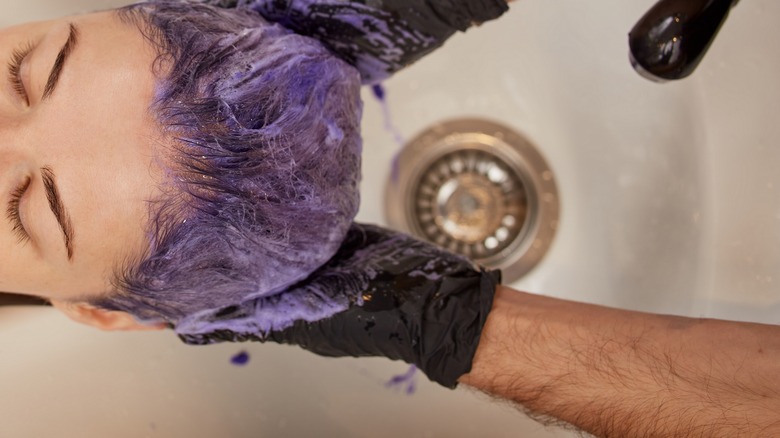 Colorist using purple shampoo 