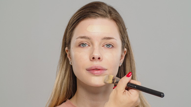woman using foundation brush 