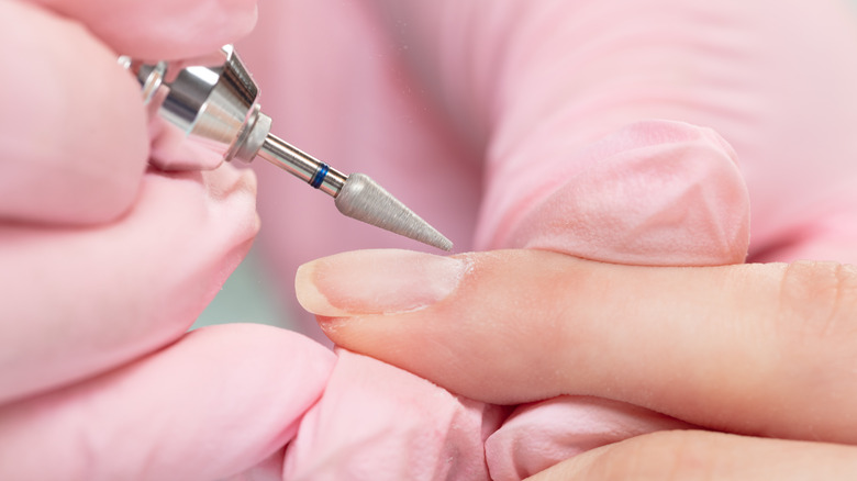 cuticles being prepped by manicurist 