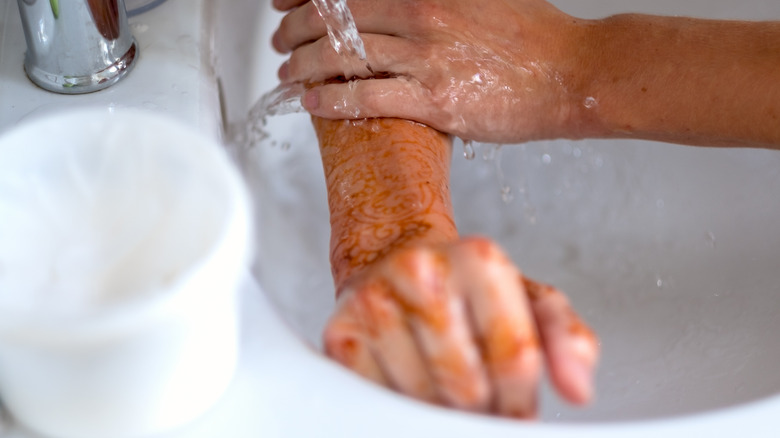 woman washing henna