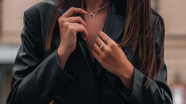 Women models silver jewelry with black leather jacket