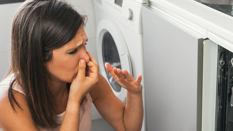 Woman holding nose