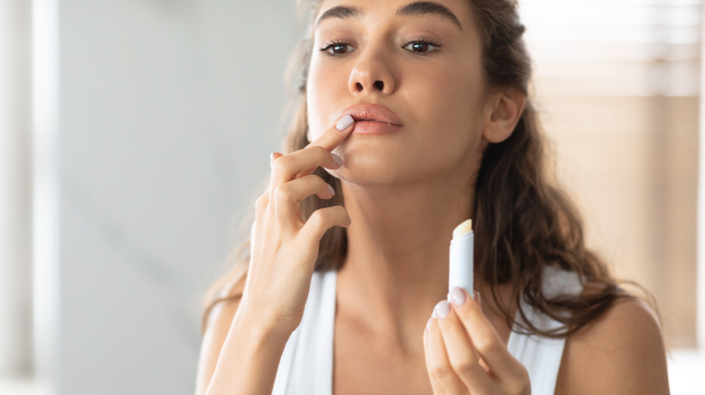woman applying lip balm 