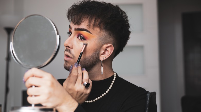 Man putting on makeup 