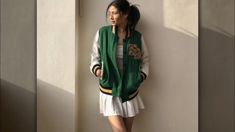 Woman in green varsity jacket