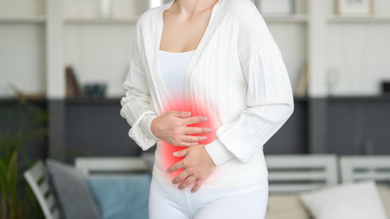 Woman grasping stomach in pain