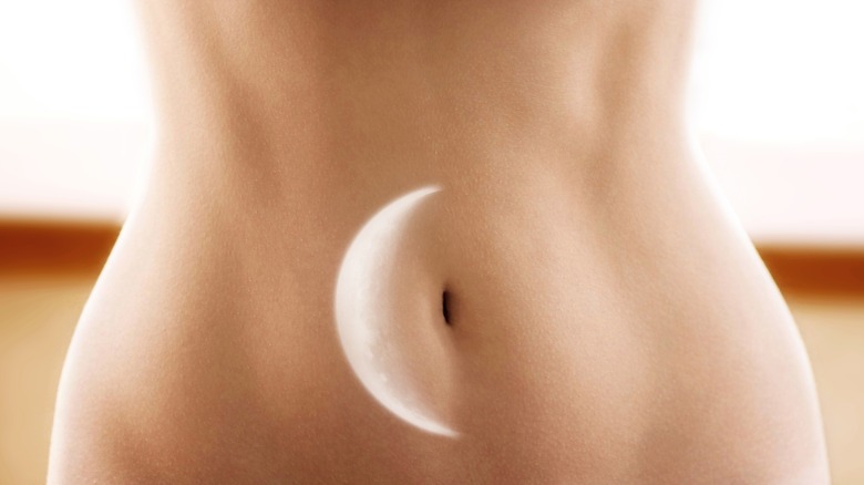 Moon phase on woman's abdomen