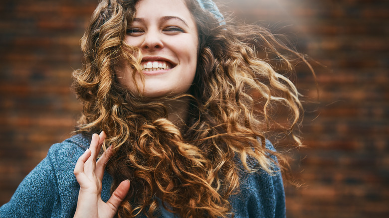 woman with curly hair smiling