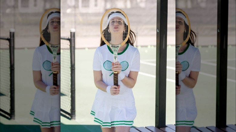 Girl wearing green tennis outfit.
