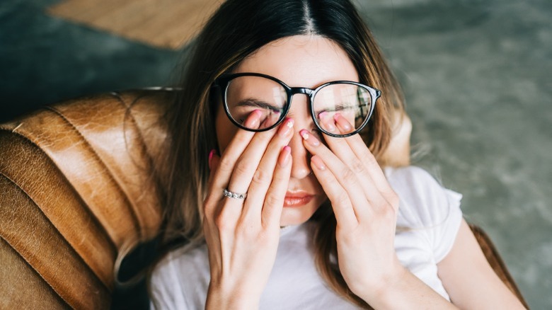 Stressed woman wearing glasses