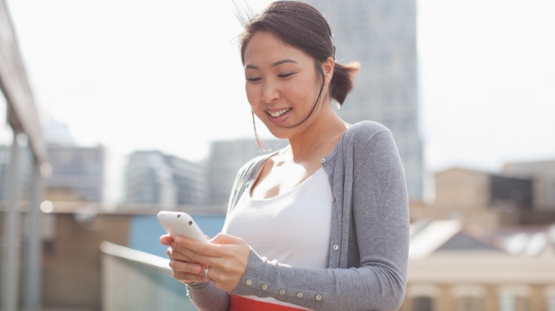 Woman texting outside