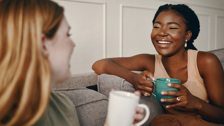 Two women chat while drinking coffee