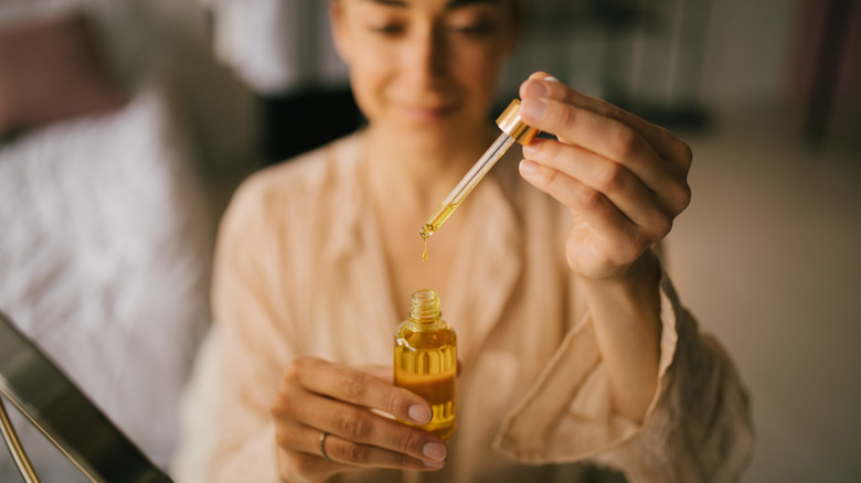 Woman holding facial oil