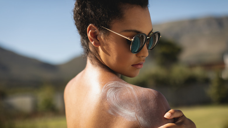 Woman applying sunscreen