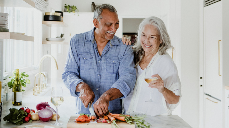 Mature couple preparing dinner together