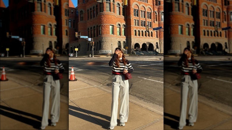 girl wearing gray trousers and striped sweater