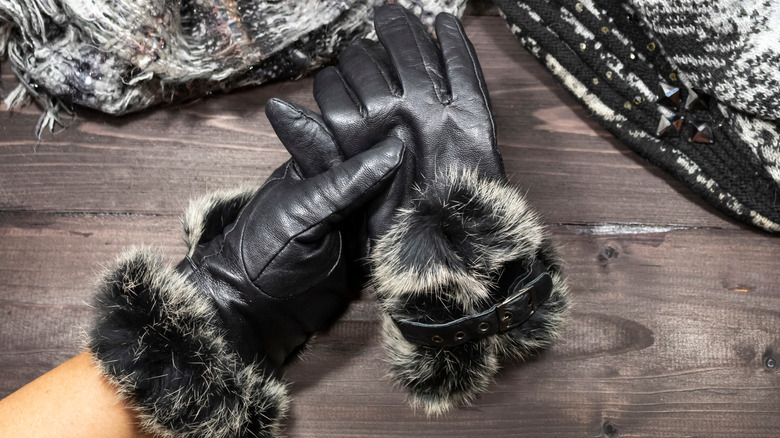 Black leather gloves with gray fur trim