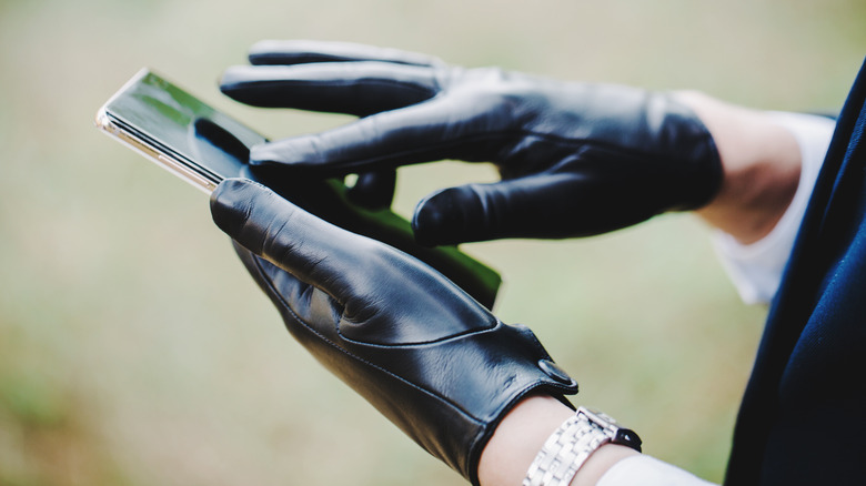 Model using touchscreen with leather gloves on