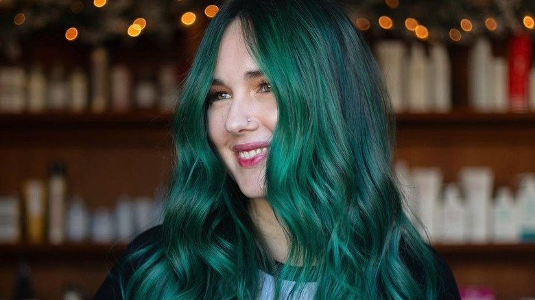 Woman with deep green hair color