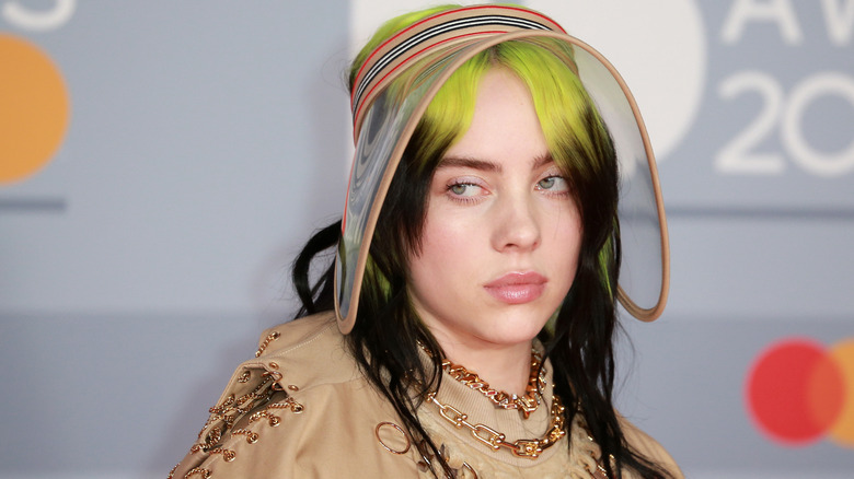 Billie Eilish with green hair roots