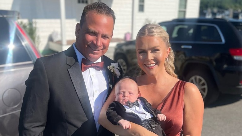 Karoline Leavitt at a wedding with her baby and husband, Nicholas Riccio.