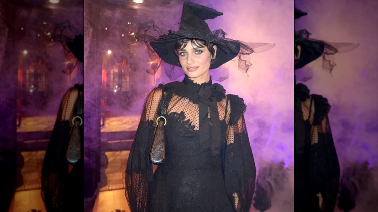 Taylor Hill dressed as a witch at Jinx halloween party