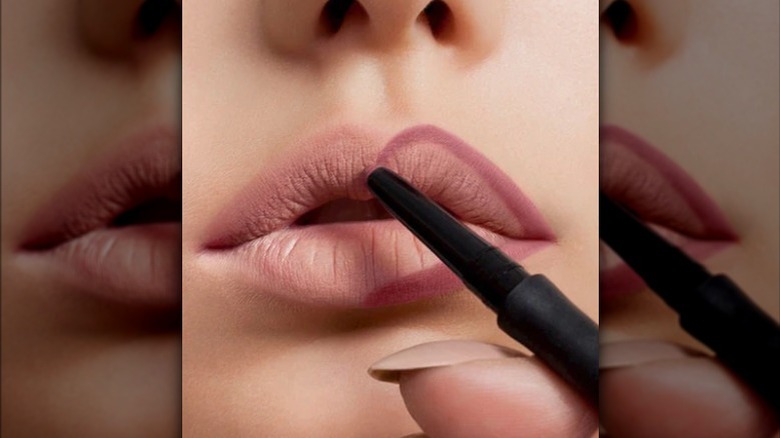 lips being outlined with lip liner