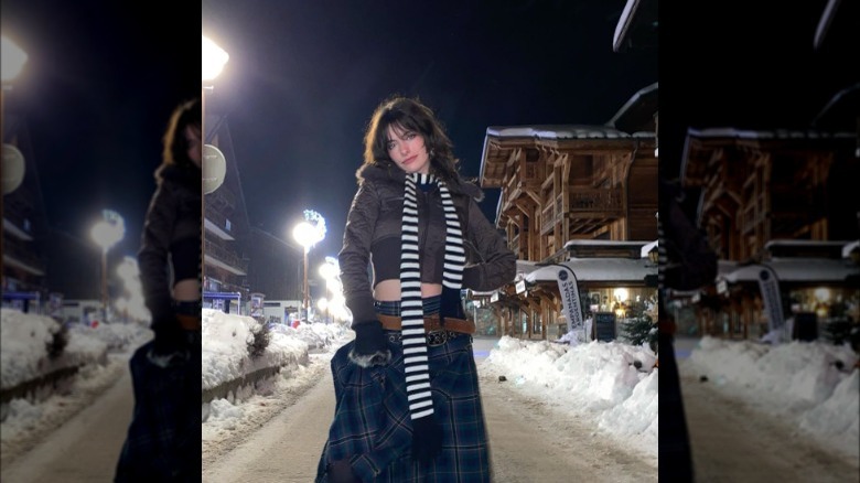 a woman wearing a striped skinny scarf