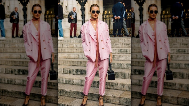 a woman wearing a pink skinny scarf