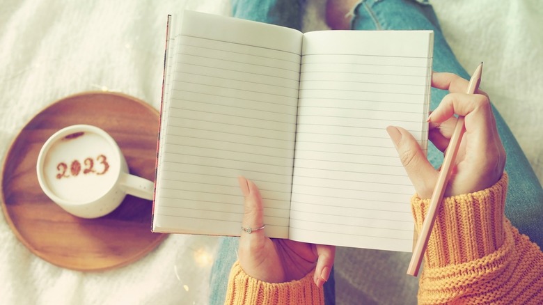 Person with notebook and coffee 