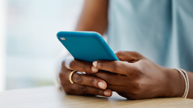 Close up of woman holding phone