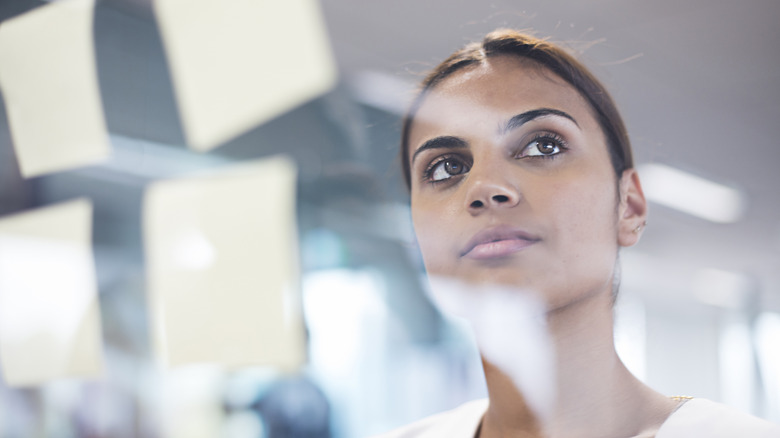 Woman staring at a whiteboard 