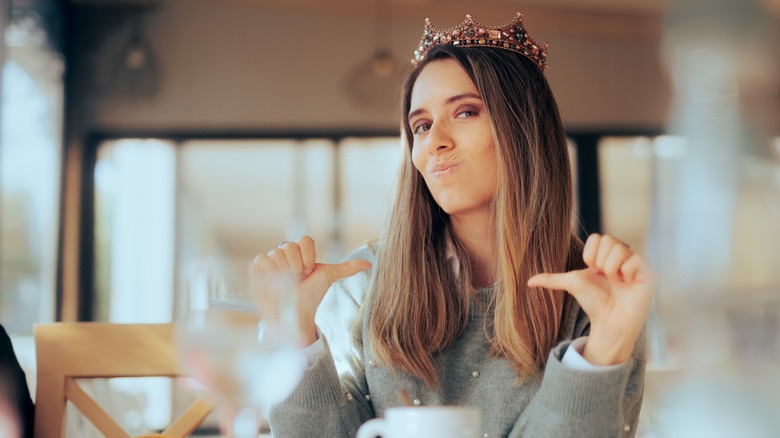 Self-centered woman wearing a crown