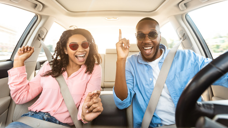 couple dancing in car