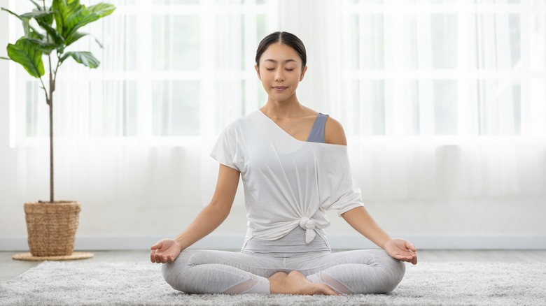 woman meditating at home