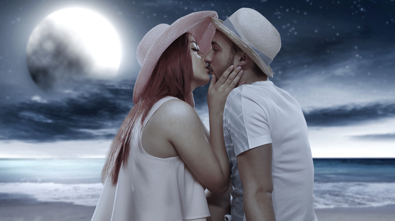 Couple kissing under the moonlight 