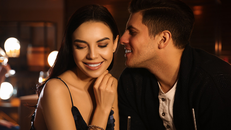 Couple flirting at a bar