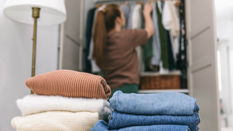 woman organizing clothes in closet