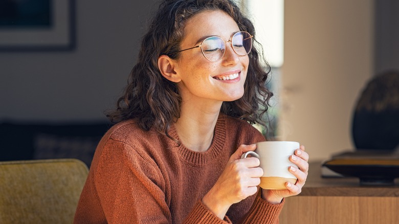 Calm smiling woman holding mug