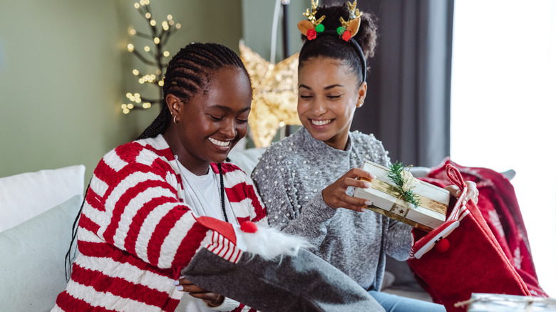 Two women exchanging holiday gifts