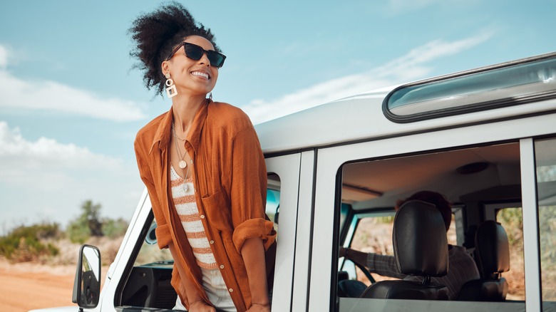 Woman leaning out of car