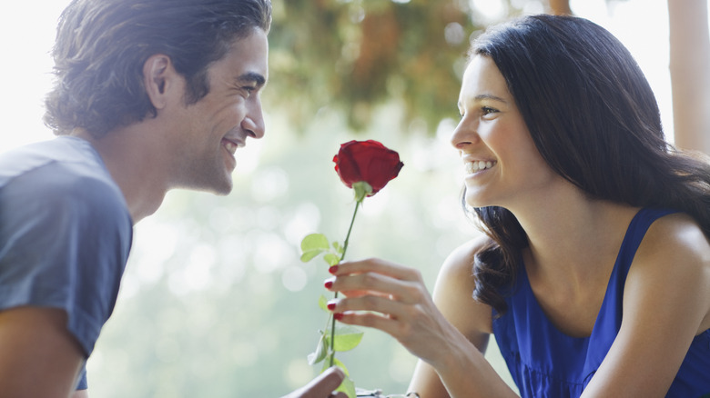 Man giving woman a rose