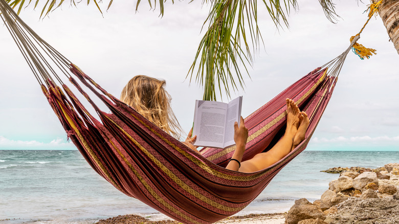 Woman reading in hammock