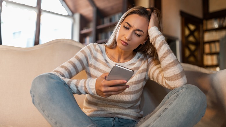 woman sitting with phone