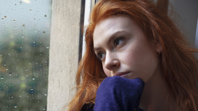 Woman looking out window 